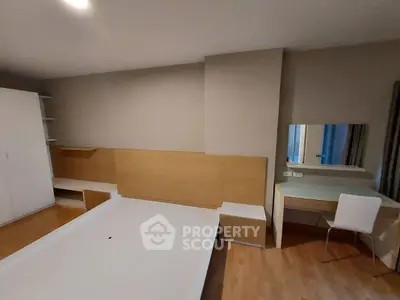 Modern bedroom with sleek furniture and built-in wardrobe