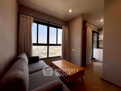 Modern living room with city view, featuring a cozy sofa and wooden coffee table.