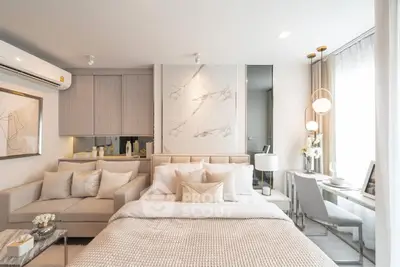 Luxurious modern bedroom with elegant decor and cozy seating area