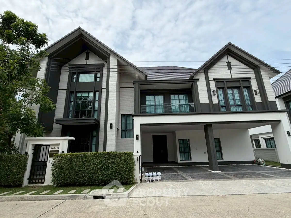 Stunning modern two-story house with spacious driveway and lush greenery, perfect for family living.