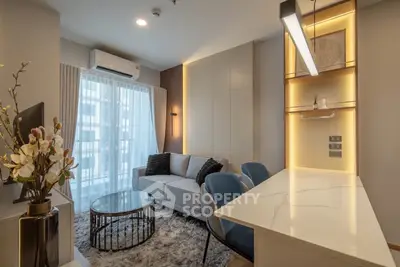 Modern living room with elegant decor, cozy seating, and ambient lighting in a stylish apartment.