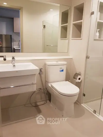Modern bathroom with sleek fixtures and glass shower enclosure