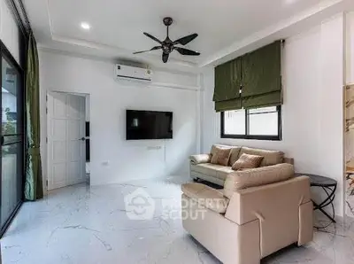 Modern living room with sleek marble flooring, stylish ceiling fan, and cozy seating area.