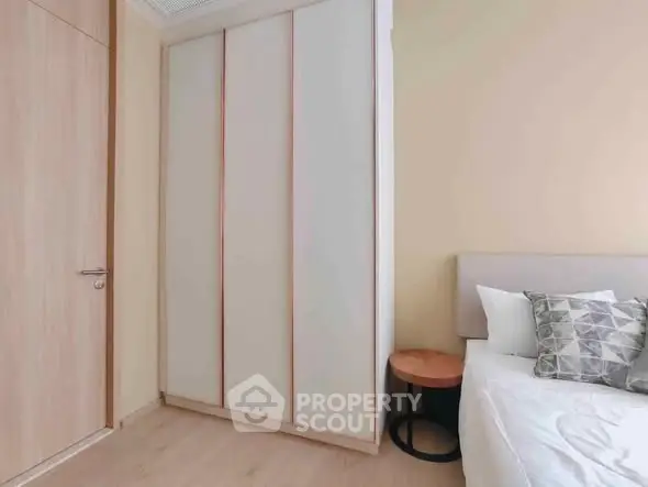 Modern bedroom with sleek wardrobe and cozy bed setup