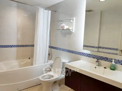 Modern bathroom with bathtub and sleek fixtures in a stylish apartment.