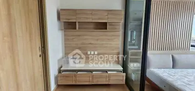 Modern bedroom with wooden storage and sleek design elements