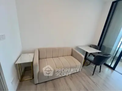 Modern living room with elegant beige sofa and stylish marble tables
