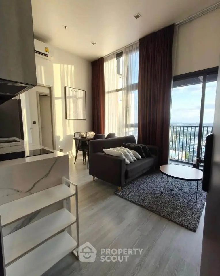 Modern living room with high ceilings and large windows offering stunning views.