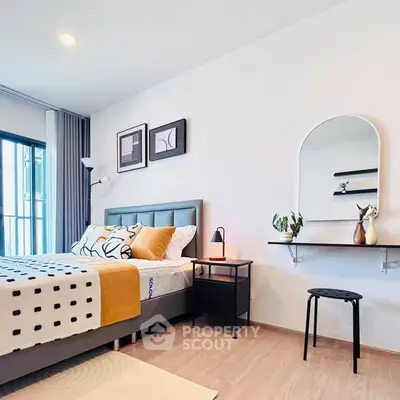Modern bedroom with stylish decor and natural light, featuring a cozy bed and elegant wall art.