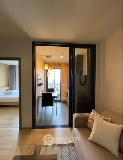 Modern apartment interior with cozy living room and dining area, featuring stylish decor and natural light.