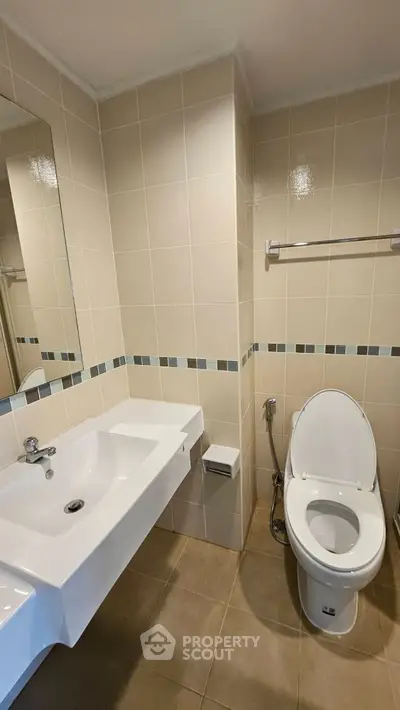 Modern bathroom with sleek fixtures and neutral tiles