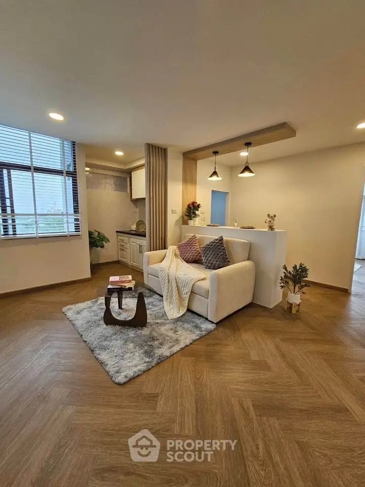 Modern living room with cozy sofa and open kitchen layout