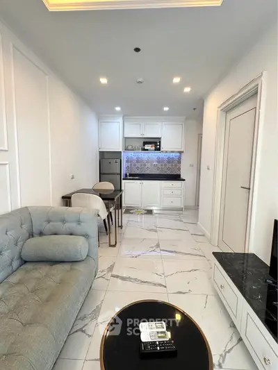Modern living room with elegant marble flooring and stylish kitchen in open layout.