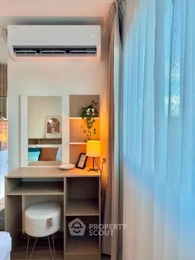 Chic bedroom corner with stylish vanity, soft lighting, and modern air conditioning unit.
