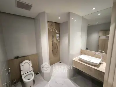 Modern bathroom with sleek fixtures and spacious shower area