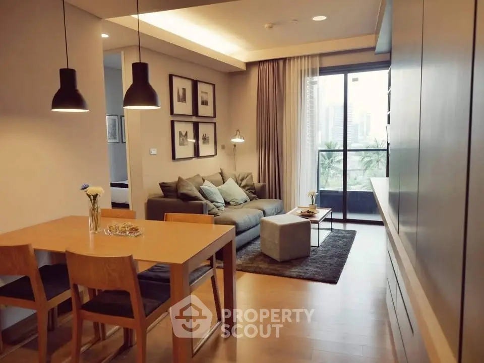 Modern living room with dining area and city view balcony in stylish apartment.
