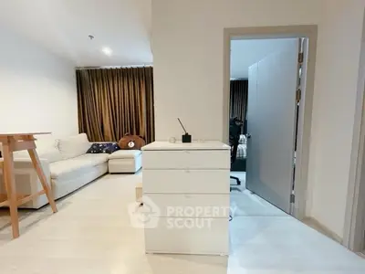Modern living room with cozy sofa and stylish decor in a contemporary apartment.