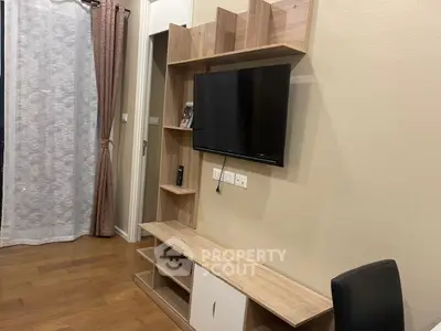 Modern living room with sleek TV unit and wooden flooring