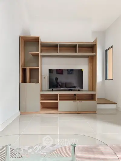 Modern living room with sleek TV unit and minimalist decor