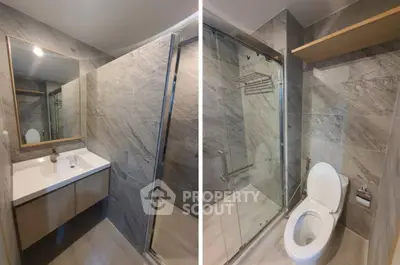 Modern bathroom with sleek design, featuring a glass shower and elegant vanity.