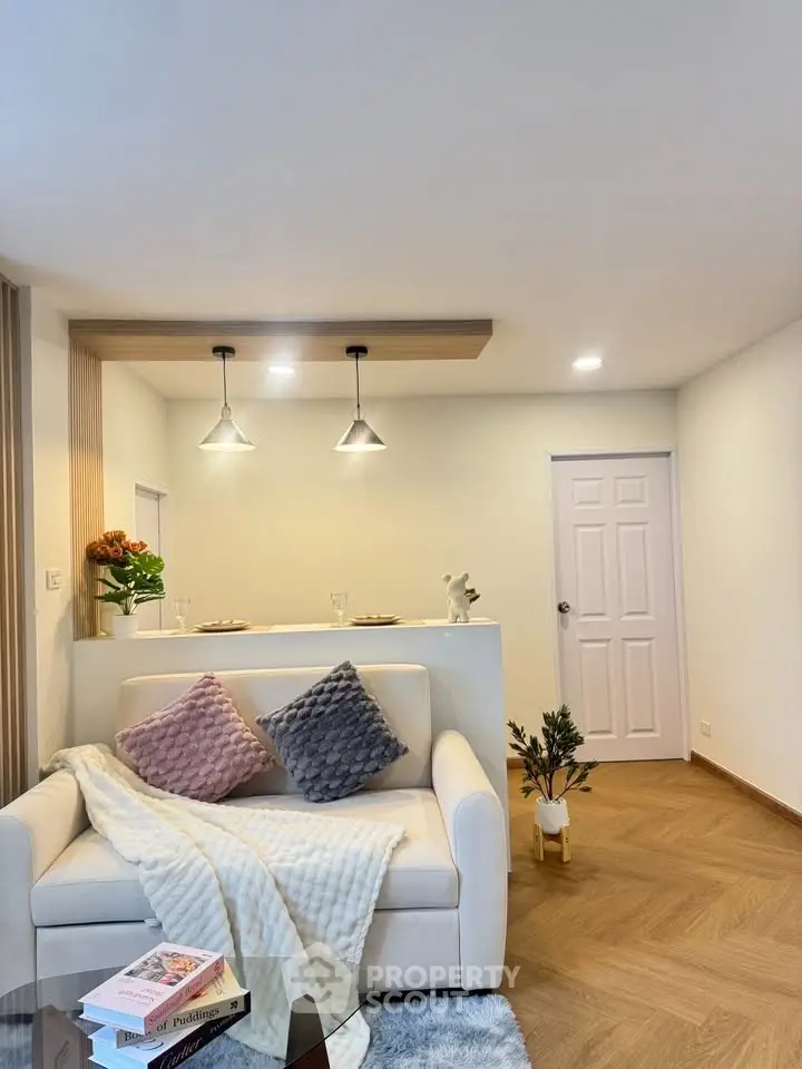 Modern living room with cozy sofa and stylish lighting, perfect for relaxation.