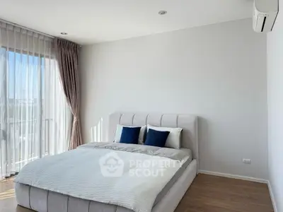 Modern bedroom with large window and elegant decor