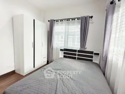 Cozy bedroom with modern decor and ample natural light