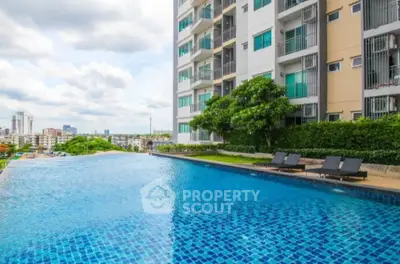 Luxurious apartment building with stunning infinity pool and city view.