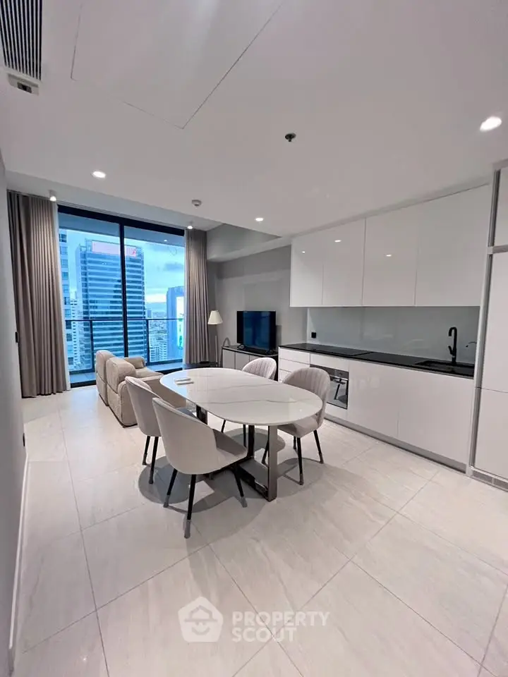 Modern open-plan living room with city view, sleek kitchen, and elegant dining area.