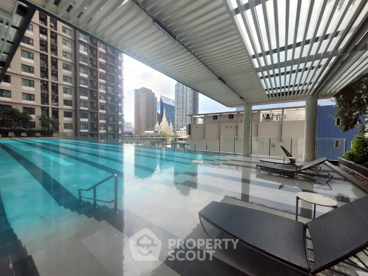 Luxurious rooftop pool with stunning city views and modern lounge chairs.