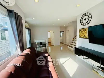 Spacious living room with modern decor and natural light