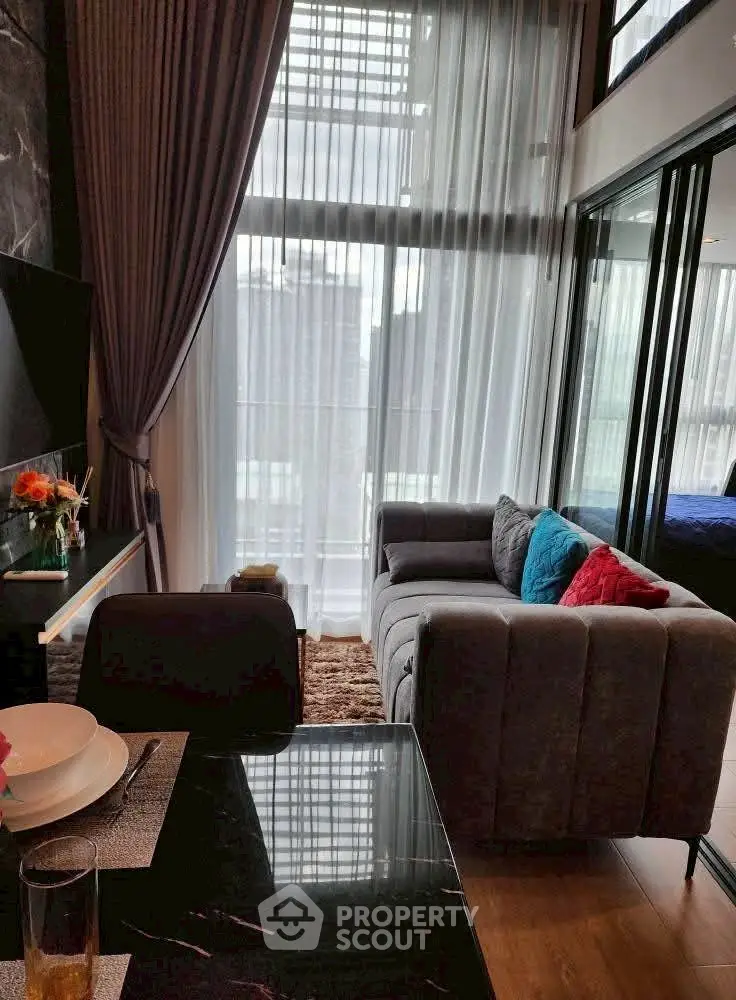 Modern living room with floor-to-ceiling windows and stylish decor