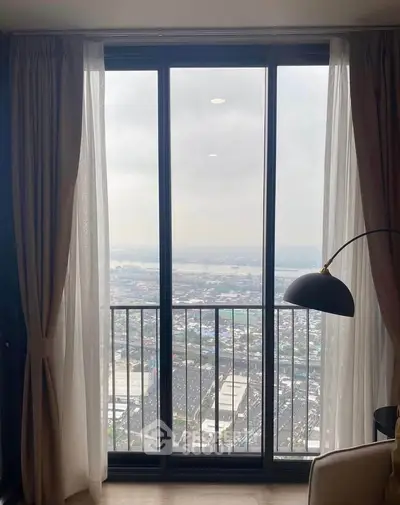 Stunning high-rise apartment view with floor-to-ceiling windows overlooking the cityscape.