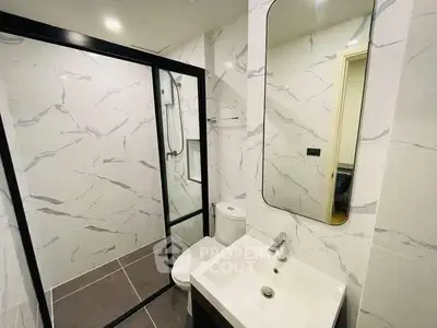 Modern bathroom with sleek design and glass shower enclosure