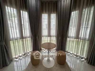 Elegant corner unit with floor-to-ceiling windows and stylish decor