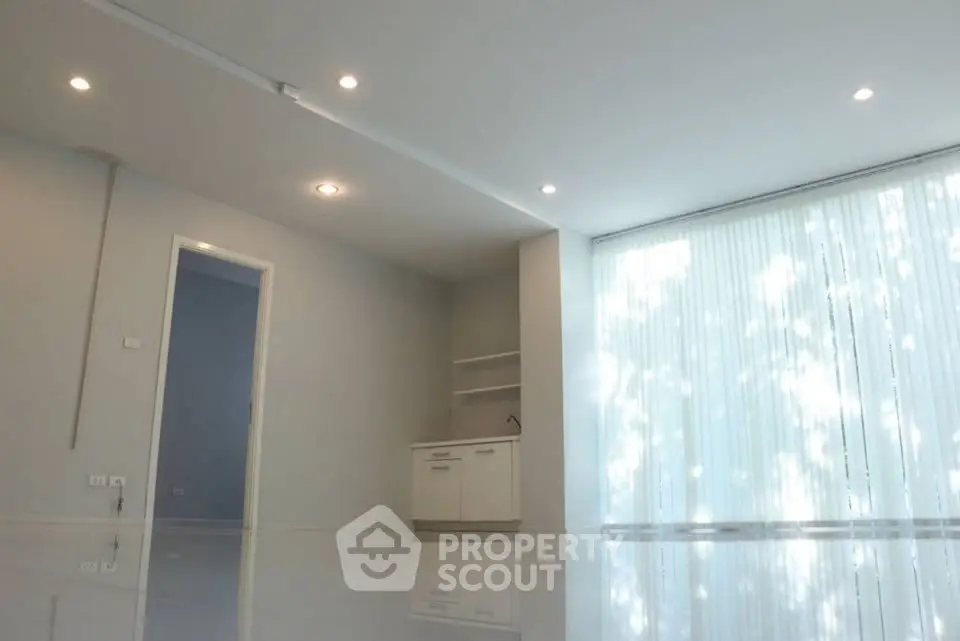 Spacious modern living room with sleek design and large windows for natural light.