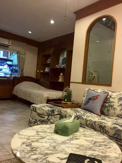 Charming living room with cozy seating and elegant decor, perfect for relaxation and entertainment.