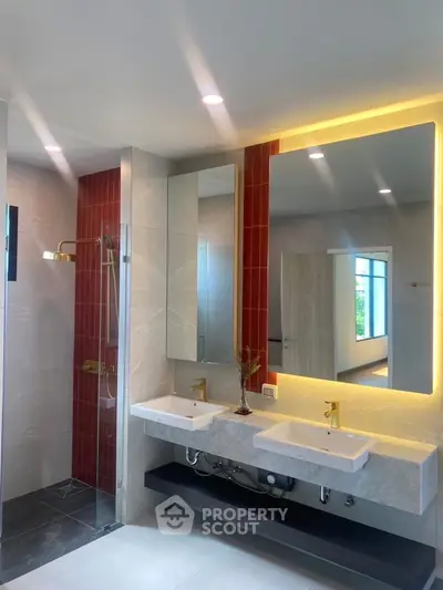 Modern bathroom with dual sinks and illuminated mirror