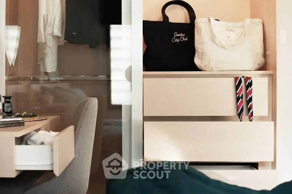 Modern bedroom with stylish closet and workspace, featuring elegant decor and ample storage.