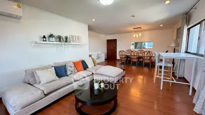 Spacious living room with cozy seating and elegant dining area, perfect for family gatherings.