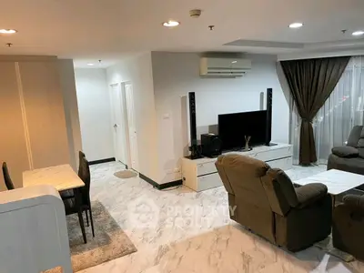 Spacious modern living room with marble flooring and cozy seating area.