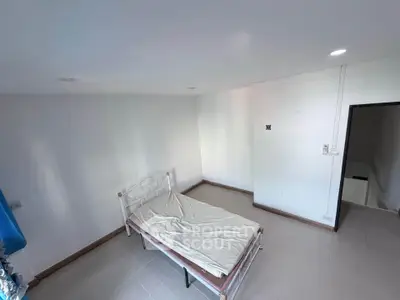 Minimalist bedroom with single bed and white walls, ideal for cozy living.