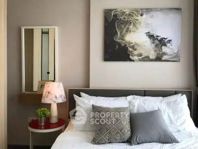 Cozy bedroom with modern decor and stylish artwork above bed