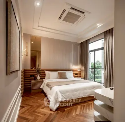 Luxurious bedroom with elegant design and large window offering natural light and scenic view.