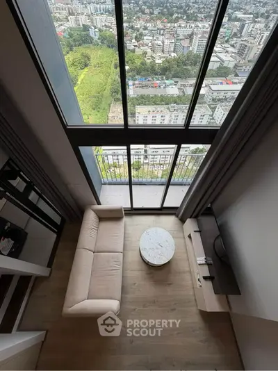 Stunning high-rise apartment with floor-to-ceiling windows and breathtaking city view.