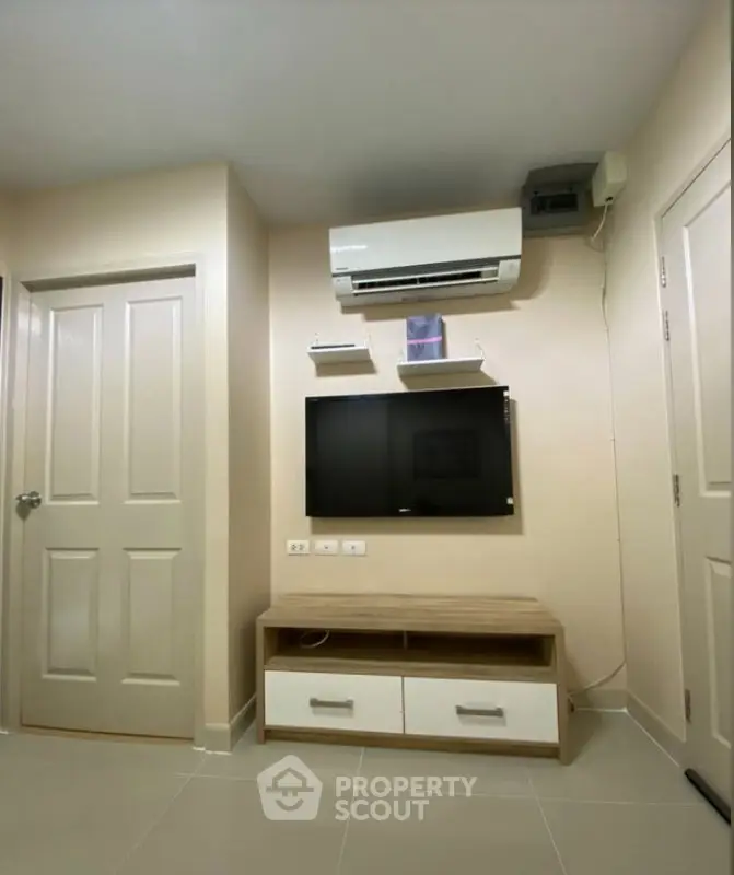 Modern living room with wall-mounted TV and air conditioning unit