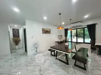 Spacious modern living room with elegant marble flooring and stylish dining area.