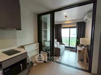 Modern living room with sliding glass doors and balcony view in a stylish apartment.