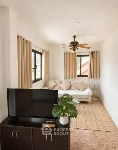 Charming living room with natural light, cozy sofa, and modern decor in a bright, inviting space.