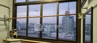 Stunning cityscape view from a high-rise window, showcasing urban skyline at dusk.